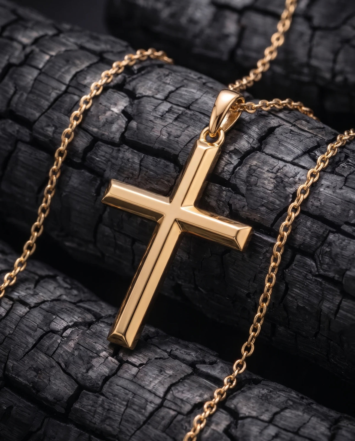 Facet Cross gold pendant at an angle showing beveled arms and chain