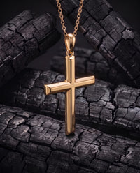 Facet Cross gold pendant turned to show its solid square-section depth and bail