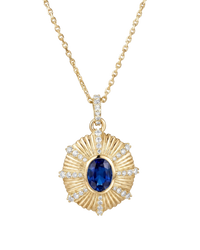 Gold necklace with a blue gemstone pendant on a white background