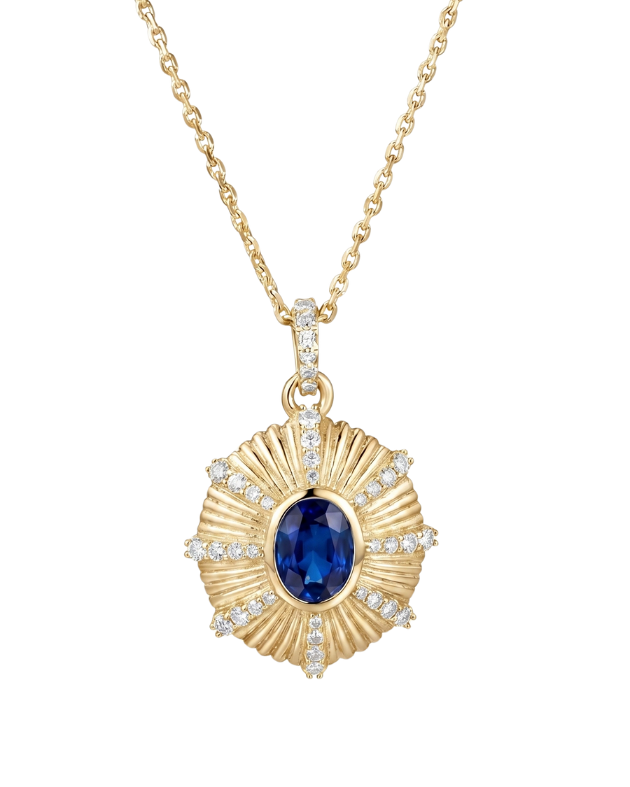 Gold necklace with a blue gemstone pendant on a white background